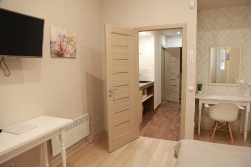 a bedroom with a desk and a computer in a room at WINE & ROSE BOUTIQUE HOTEL in Kharkiv