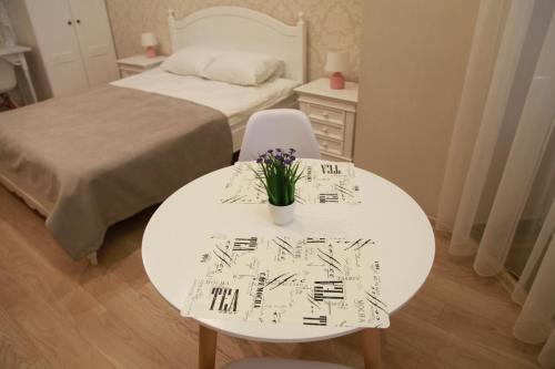 a room with a white table with flowers on it at WINE & ROSE BOUTIQUE HOTEL in Kharkiv