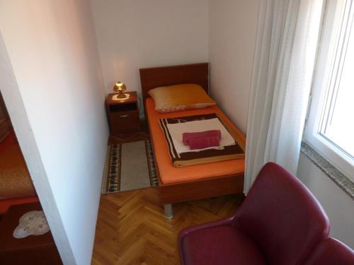 a small room with a bed and a window at Cozy apartments near Queen beach Nin - Karlovacka I in Nin