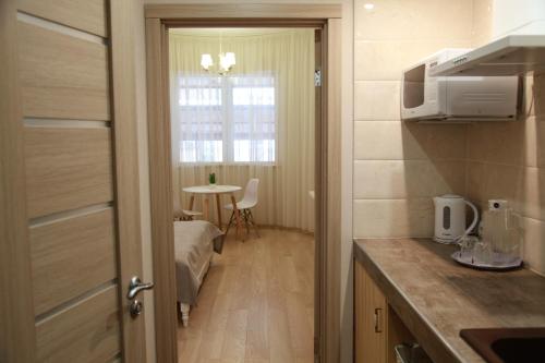 a small room with a kitchen and a table at WINE & ROSE BOUTIQUE HOTEL in Kharkiv