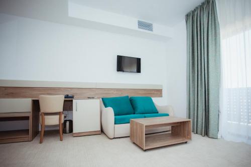a living room with a blue couch and a table at Tci Social Club in Cluj-Napoca
