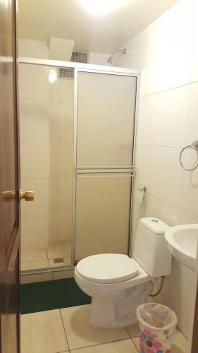 a bathroom with a toilet and a sink at Hotel Nuevo Sol in La Paz