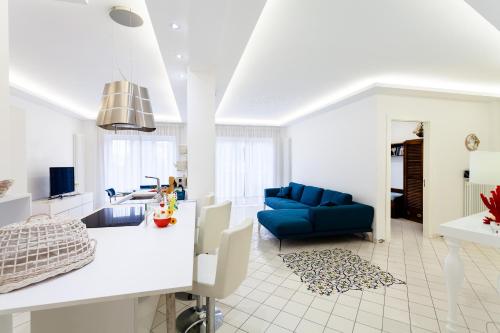 a living room with a blue couch and a table at Matilde Home in Sorrento