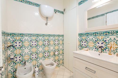 a bathroom with a toilet and a sink at Matilde Home in Sorrento