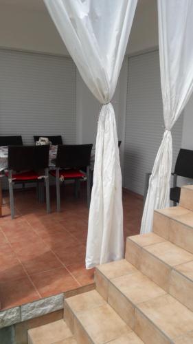 a room with stairs and a white curtain at Željko Apartmani in Lopar
