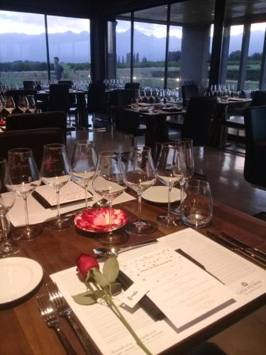 a table in a restaurant with wine glasses on it at Casa Petrini in Tupungato