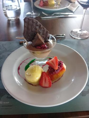 a white plate with desserts on a table at Casa Petrini in Tupungato