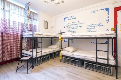 a room with three bunk beds in it at Hostel ROOM Rotterdam in Rotterdam