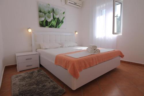 a bedroom with a bed with a teddy bear on it at Luxury Apartment Stefan in Sveti Stefan
