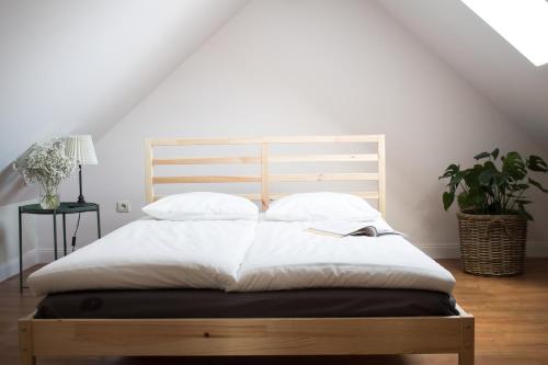 a bed with white sheets and pillows in a room at Święty Spokój in Radków
