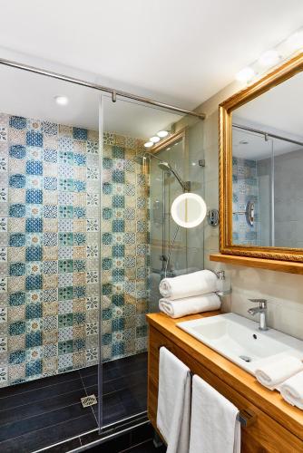 a bathroom with a sink and a shower at Stylish and High-end Designer Apartments in City Center in Sofia