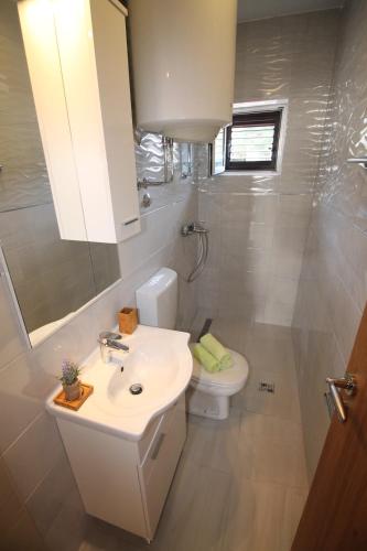 a bathroom with a sink and a toilet at Luxury Apartment Stefan in Sveti Stefan