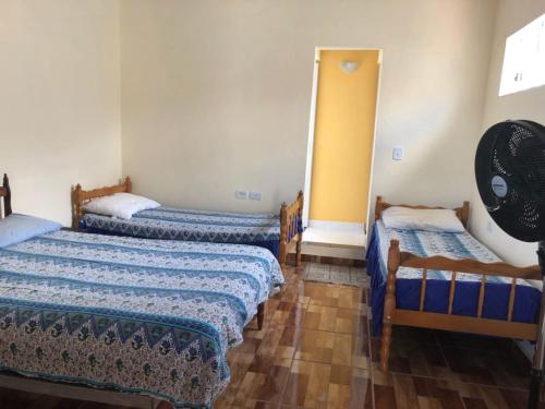 a room with two beds and a mirror at Casa Benta in Aparecida