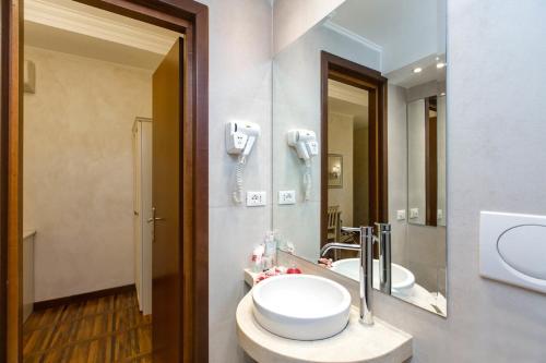 a bathroom with a sink and a mirror at Locanda Navona in Rome