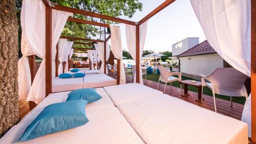 a porch with two beds and chairs on a balcony at My Soul Resort in Knić