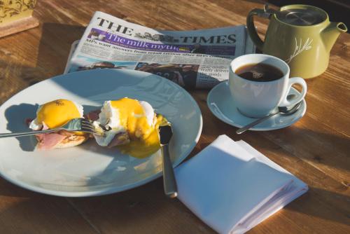 a plate of food on a table with a cup of coffee at The Haughmond in Shrewsbury