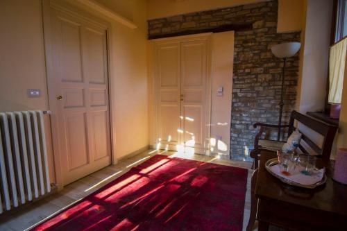a room with a door and a red rug at Agriturismo Poderi Zunino in Ponti