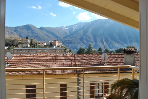 a view of a building with mountains in the background at Attico with swimming pool in Lenno