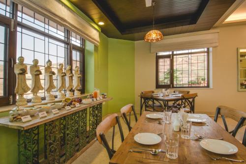 a dining room with a long table and chairs at The Almond Tree in Jodhpur
