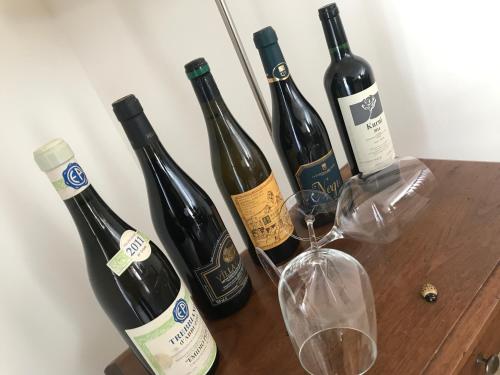 four bottles of wine sitting on a wooden table at Ellebì B&B in Montone