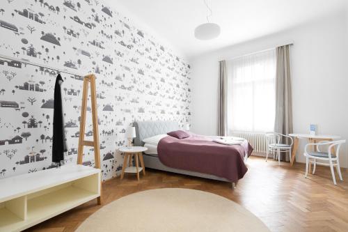 a bedroom with a bed and a wall covered in birds at Best Place in Prague in Prague