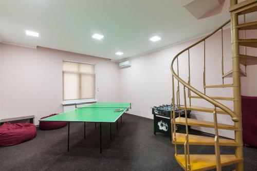 a room with a ping pong table and a staircase at Lux Apart Lviv apartments in Lviv