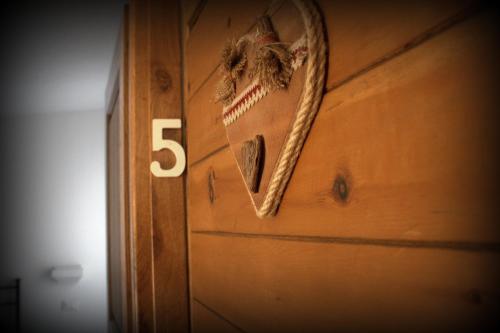 a wooden door with the number on it at Il Girasole in Saint Vincent
