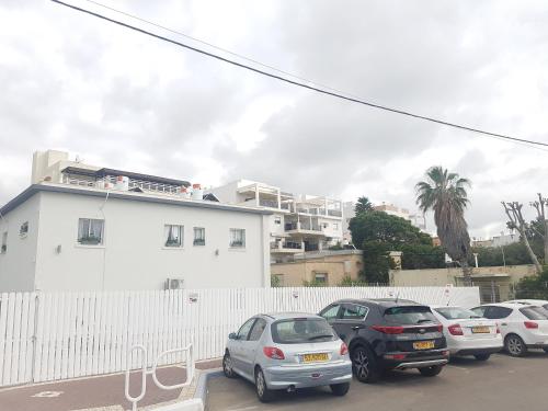 a group of cars parked in a parking lot at אבני החושן- Avnei Hoshen in Nahariyya
