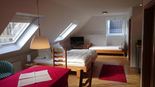 a small bedroom with two beds and a tv at Hotel zur Brücke in Kevelaer