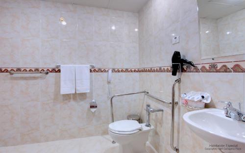 a person standing on a toilet in a bathroom at Hotel Cartagena Plaza in Cartagena de Indias