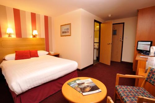 a hotel room with a bed and a table at Patterdale Hotel in Patterdale