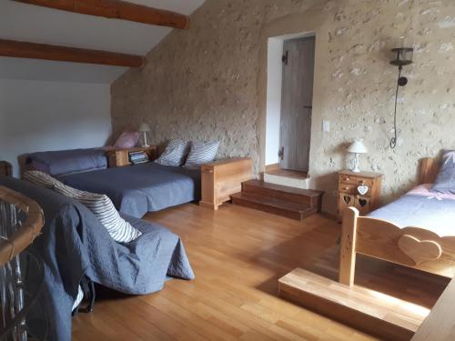a living room with a couch and a bed and a table at Mas de la Frigoule in Le Pouget