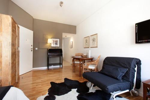 a living room with a couch and a table at PortoSense Ribeira in Porto