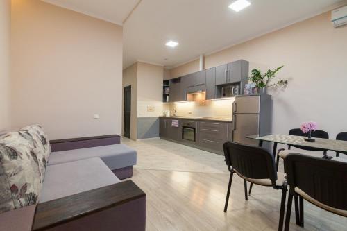 a living room with a couch and a table at Lux Apart Lviv apartments in Lviv