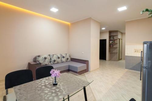a living room with a couch and a table at Lux Apart Lviv apartments in Lviv