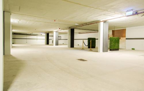an empty room with white floors and white ceilings at Grand Plaza Hotel Nampula in Nampula
