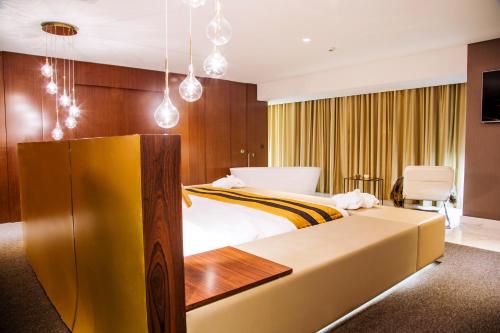 a hotel room with a large bed and a tv at Grand Plaza Hotel Nampula in Nampula
