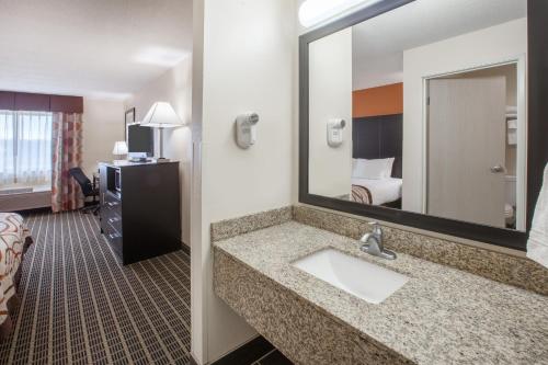 a bathroom with a sink in a hotel room at Baymont by Wyndham South Haven in South Haven