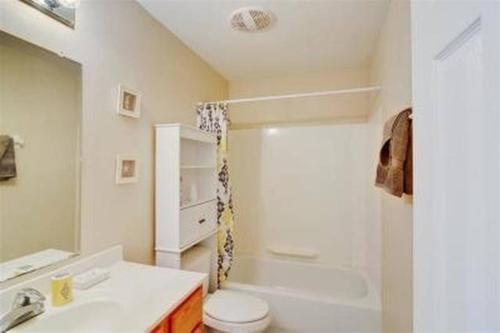 a bathroom with a sink and a toilet and a shower at Beach Comber at Oak Shores in Biloxi