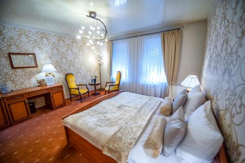 a hotel room with two beds and a large window at Hotel Imperium in Piekary Śląskie