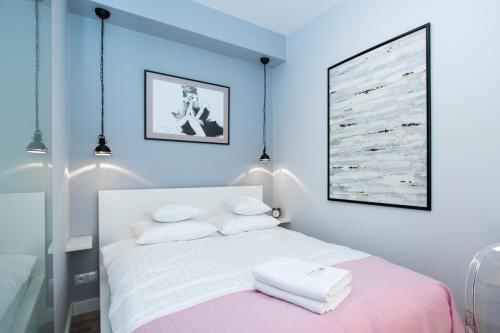 a bedroom with a bed with two towels on it at Apartamenty Złota 15 in Kielce