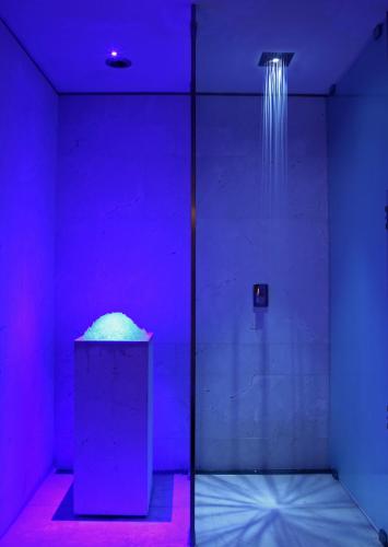 a room with a shower with a purple light at Hotel Cristoforo Colombo Member of Preferred Hotels & Resorts in Milan