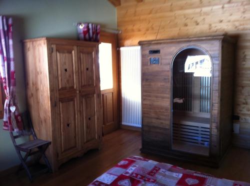 a living room with a wooden room with a fireplace at Hotel L'espoir in Champoluc