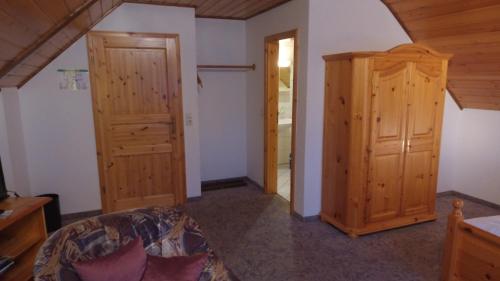 a living room with a couch and a closet at Landgasthof Rademacher in Finnentrop