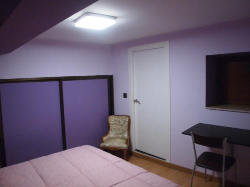 a bedroom with a bed and a table and a chair at Minaya in Burgos