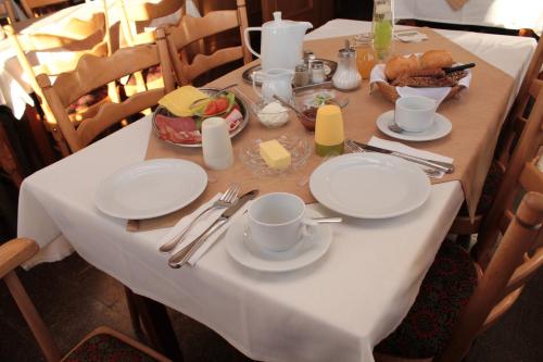 a table with plates and cups and food on it at Landgasthof Rademacher in Finnentrop