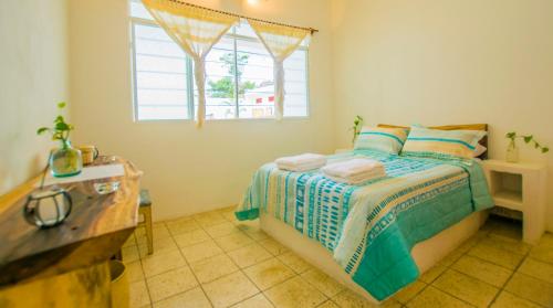 a bedroom with a bed and a window at Casa Pancho Playa in San Francisco