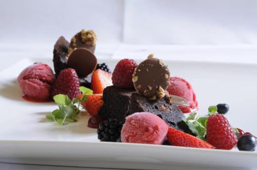 a plate of chocolate desserts with strawberries and berries at Boutique Hotel Slenaker Vallei - Buitengewoongenieten in Slenaken