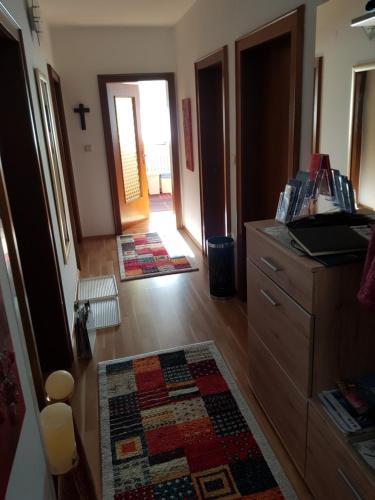 a room with a dresser and a cross on the wall at Ferienwohnung Stock in Rinn