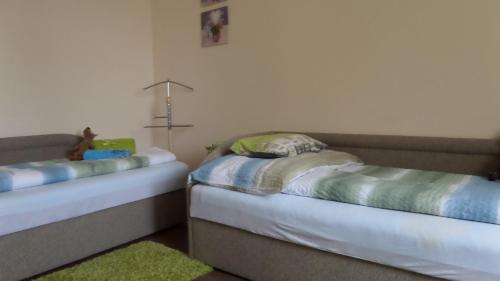 two beds in a room with a laptop on them at Rex Apartman in Hajdúszoboszló